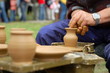 hands of a potter, creating an earthen jar on the circle