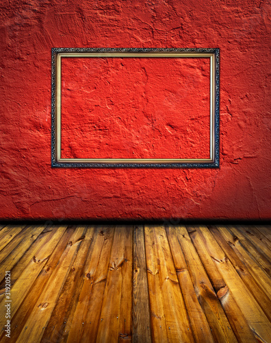 Photo: vintage red terracotta interior with empty classic frame hanging vintage red terracotta interior with empty classic frame hanging
