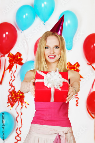 Photo: Happy girl holding gift Happy girl holding gift