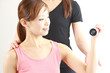 young japanese woman doing dumbbell exercise