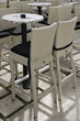 Empty pavement café rattan chairs and tables in Split