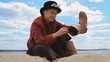 young woman shaking sand out of her boot