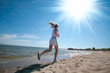 Sport woman running in sea coast