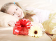 beautiful ten years' girl has seen in bed a gift on birthday.