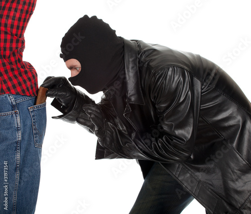 Photo: thief in black jacket and balaclava - pickpocket in action thief in black jacket and balaclava - pickpocket in action