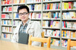 Handsome man sitting and reading in library