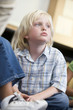 Boy daydreaming at kindergarten