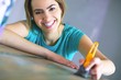 portrait of young woman with painting tools