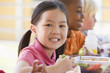 Kindergarten children eating lunch