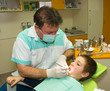 Dentist and young boy in exam room