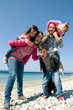 Happy family having fun by the sea