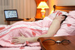 One sleeping man in the bed from back view
