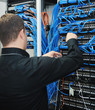 young it engeneer in datacenter server room young it engeneer in datacenter server room