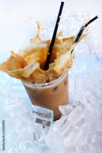 Photo: Cold coffee drink with ice and splashes Cold coffee drink with ice and splashes