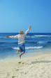 happy  woman jumping on the beach