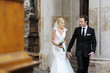 Bride and groom smiling at the church after a wedding ceremony