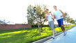 Young Couple Jogging on Suburban Roads