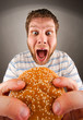 Man eating juicy hamburger