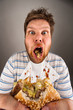 Dirty man chewing hamburger