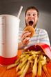 Expressive man eating fast food