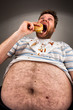 Foto: Fat man eating burger Fat man eating burger