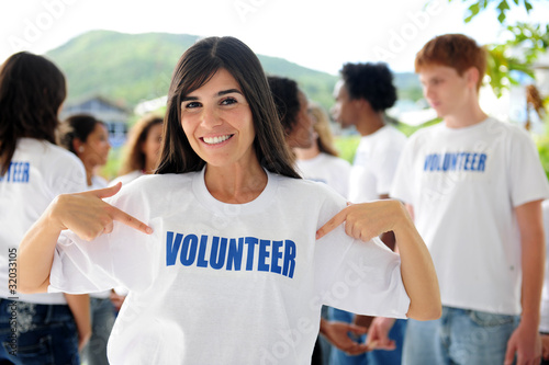 Photo: happy volunteer woman and group happy volunteer woman and group