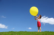 Woman holds  large inflatable ball in hands on wind