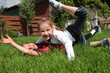 Two little girls playing on the grass