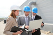 Photo: Business people meeting on industrial site Business people meeting on industrial site