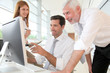 Photo: Office workers with manager in a meeting Office workers with manager in a meeting