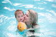 Young mother and child in blue pool