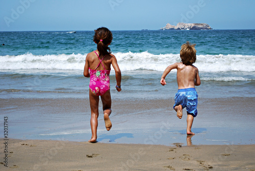Photo: Kids running towards the sea Kids running towards the sea