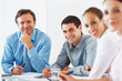 Mature executive smiling during meeting with colleagues