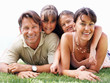Smiling family lying on grass