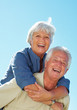 Senior couple enjoying piggyback ride