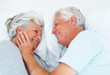 Romantic senior couple lying in bed