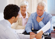 Agent discussing investment plans with a senior couple
