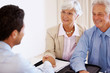 Happy old couple meeting with financial planner