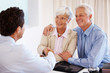 Senior couple shakes hands with their financial advisor