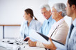Senior businesswoman at seminar amongst colleague
