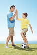 Happy man giving high five to his little son