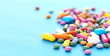 Photo: Multicolored candy sweets on blue background Multicolored candy sweets on blue background