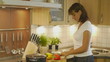 HD1080p25 Attractive woman cooking in the kitchen