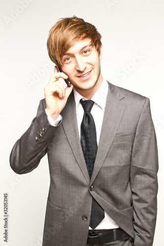 Photo: portrait of a manager with mobilephone portrait of a manager with mobilephone