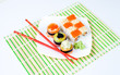 sushi on plate with two red sticks