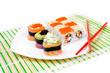 sushi on plate with two red sticks