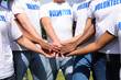 multi-ethnic volunteer group hands together