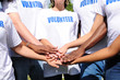 multi-ethnic volunteer group hands together