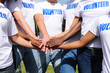 multi-ethnic volunteer group hands together