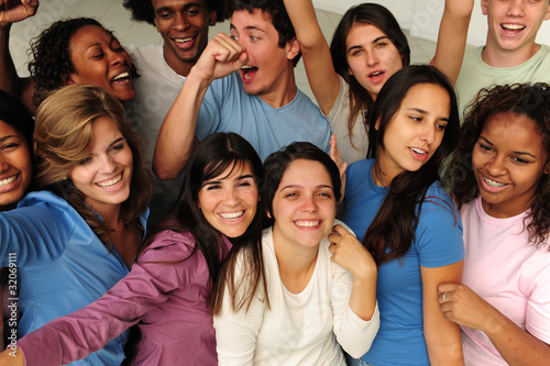 Photo: excited and happy group of diverse young people cheering excited and happy group of diverse young people cheering
